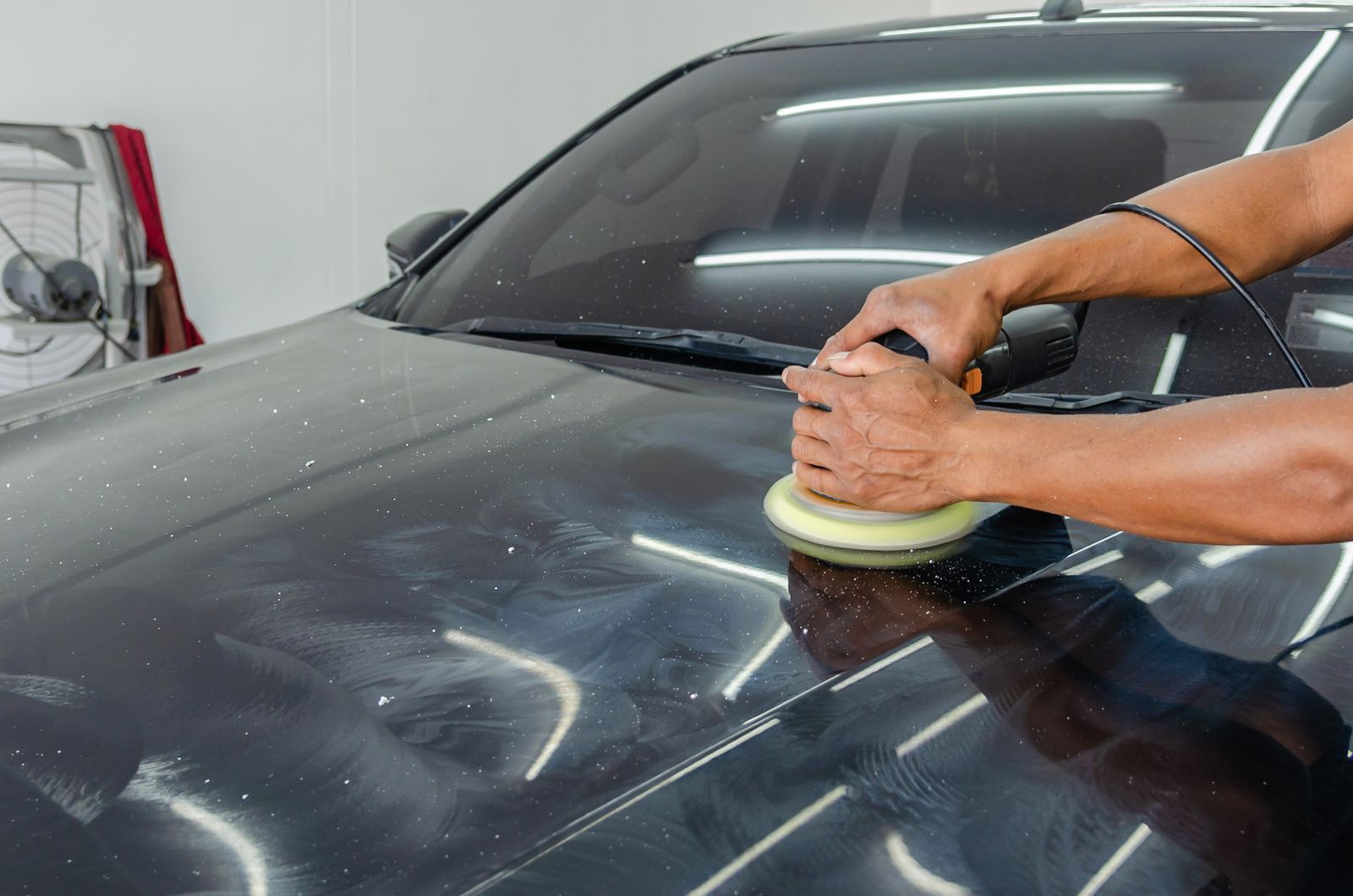 Polishing a car panel in the workshop